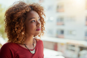 Shes an ambitious young professional. Shot of a young businesswoman standing outside on a balcony.