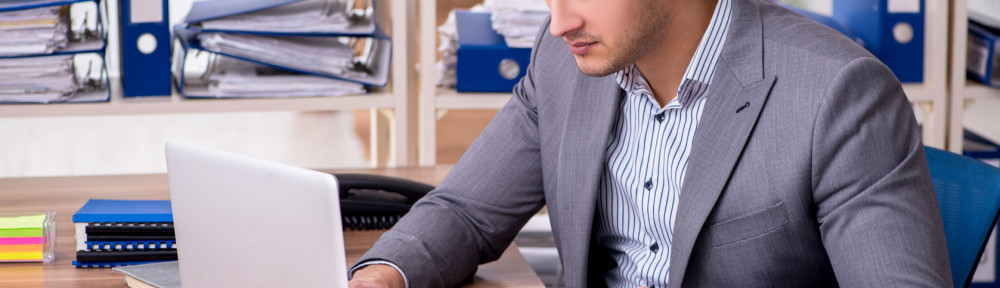 Young male employee businessman at workplace
