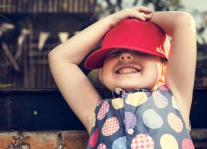 Girl is smiling with red cap