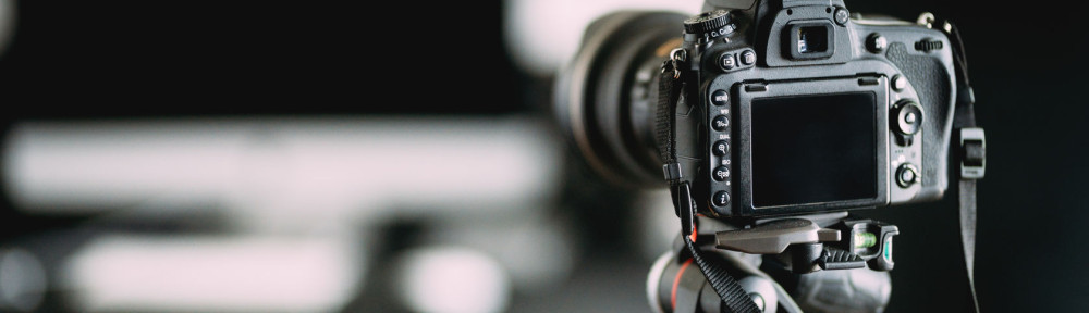 Professional photographer taking indoor pictures of newly renovated office. Camera on tripod details