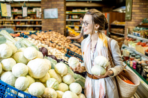 Woman buying vegetables in the supermarket