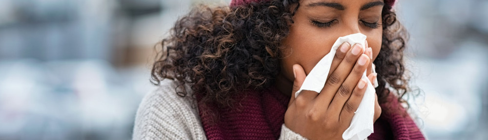 Black woman with cold sneezing outdoor