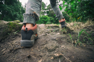 woman hiking and walking with backpack in mountains