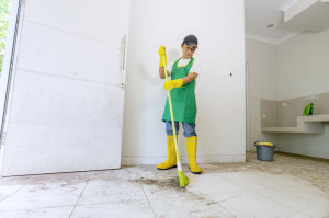 Male Asian worker cleaning dirty floor