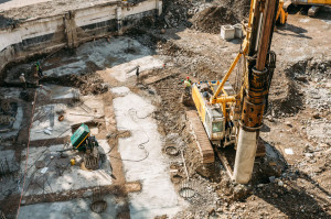 Working Construction Equipment On A Construction Site. Laying The Foundation