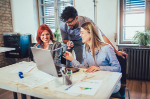 Young creative coworkers working with new startup project in off