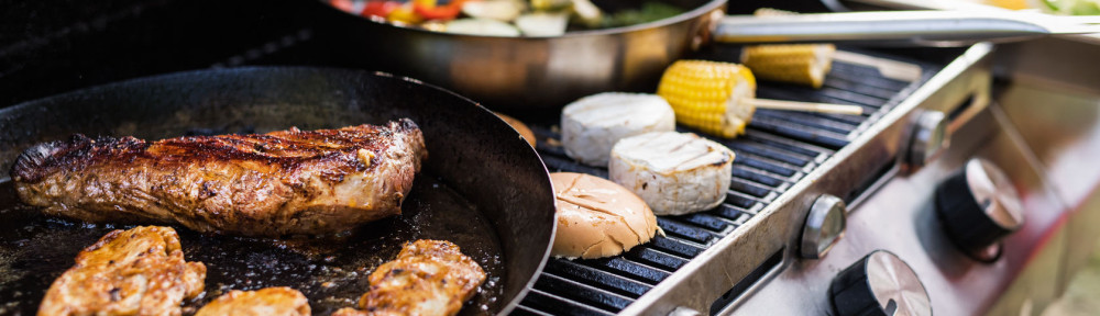 Meat and sausages on the grill. Garden party outside in the backyard.