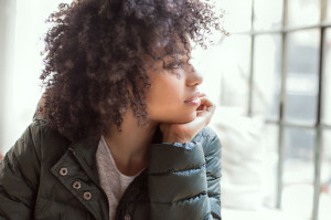 Young girl with afro using smart phone.