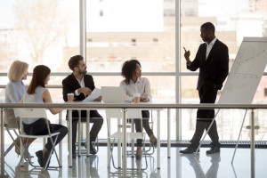 Black company owner make presentation to workers during briefing