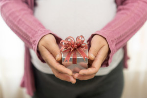 Woman hand holding gift box of christmas present.