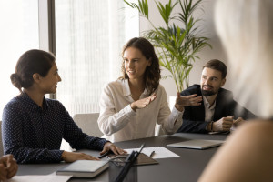 Happy engaged young employee woman offering creative marketing strategy