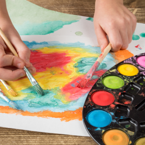 Child painting with paintbrush CANVA