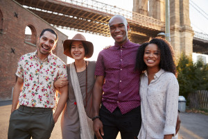 Portrait Of Friends Walking By Brooklyn Bridge In New York City