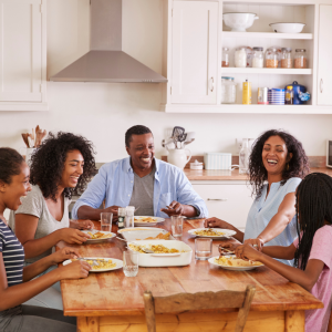 Family with Teenage Children Eating Meal in Kitchen CANVA