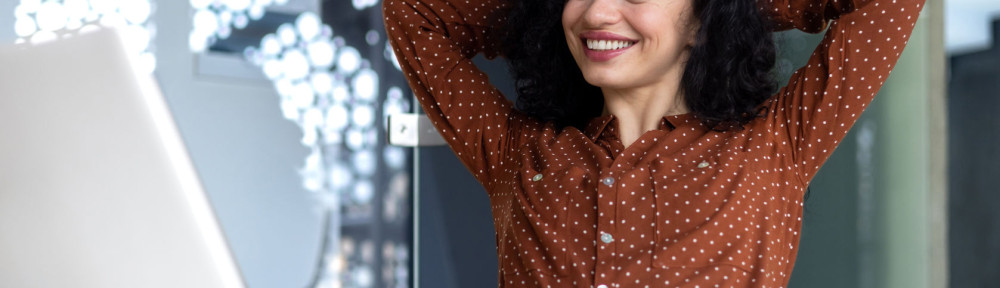Happy thinking woman at workplace inside office, business woman with hands behind head completed work well, latin american woman satisfied with achievement results looking at laptop screen