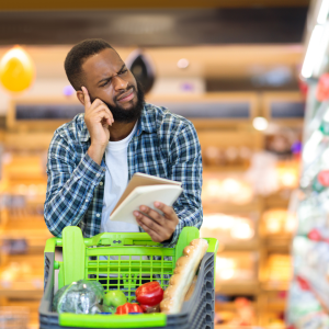 Man Buying Food With Groceries Checklist CANVA