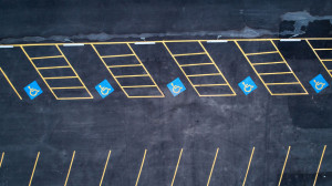 row of empty handicap parking spaces in a parking lot