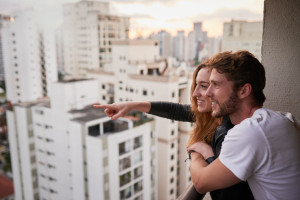 Take in the sights and you might find wonder. Cropped shot of an attractive young couple on a rooftop looking over the city.