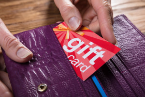 Human Hand Removing Gift Card From Purse