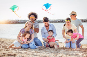 happy family on summer beachwith kids and friends