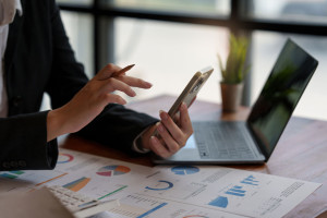 Young business woman completes KYC using an online banking program in order to open a digital savings account. The definition of cyber security.