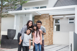 family in front of their new house