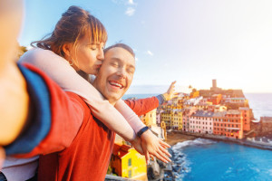 Tourists happy couple taking selfie photo of Vernazza, national park Cinque Terre, Liguria, Italy, Europe. Concept travel