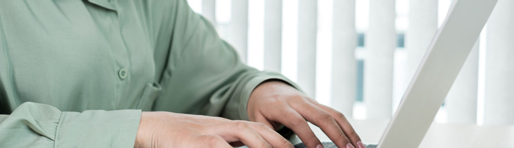 The businesswoman's hand is holding a credit card and using a la