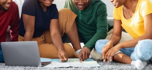 250867877 - cheerful african american friends looking for destination to travel