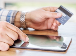 84378126 - online shopping using credit card and tablet computer.